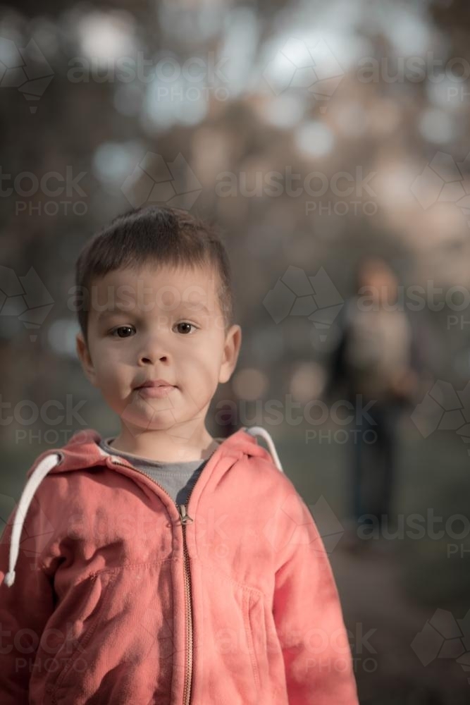 Mixed race boys walk with their Asian mother in a Sydney suburban park - Australian Stock Image