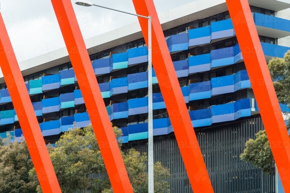 Modern, coloured columns in front a multi-story building - Australian Stock Image