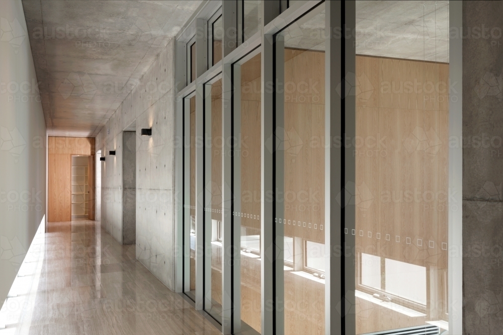 Modern hallway with floorboards and glass doors - Australian Stock Image