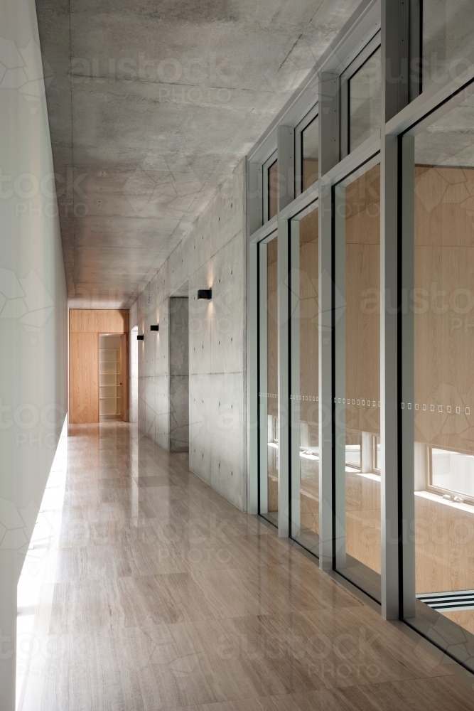 Modern hallway with floorboards and glass doors - Australian Stock Image