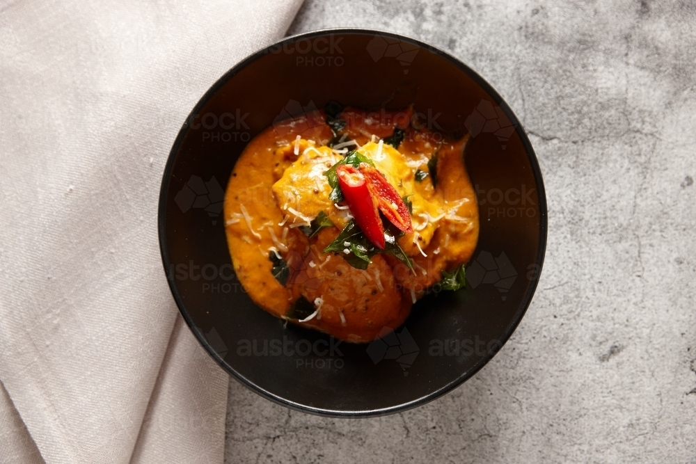 Moilee fish dish on table - Australian Stock Image