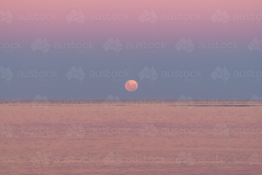 Moon going down over ocean, Victor Harbour, South Australia - Australian Stock Image