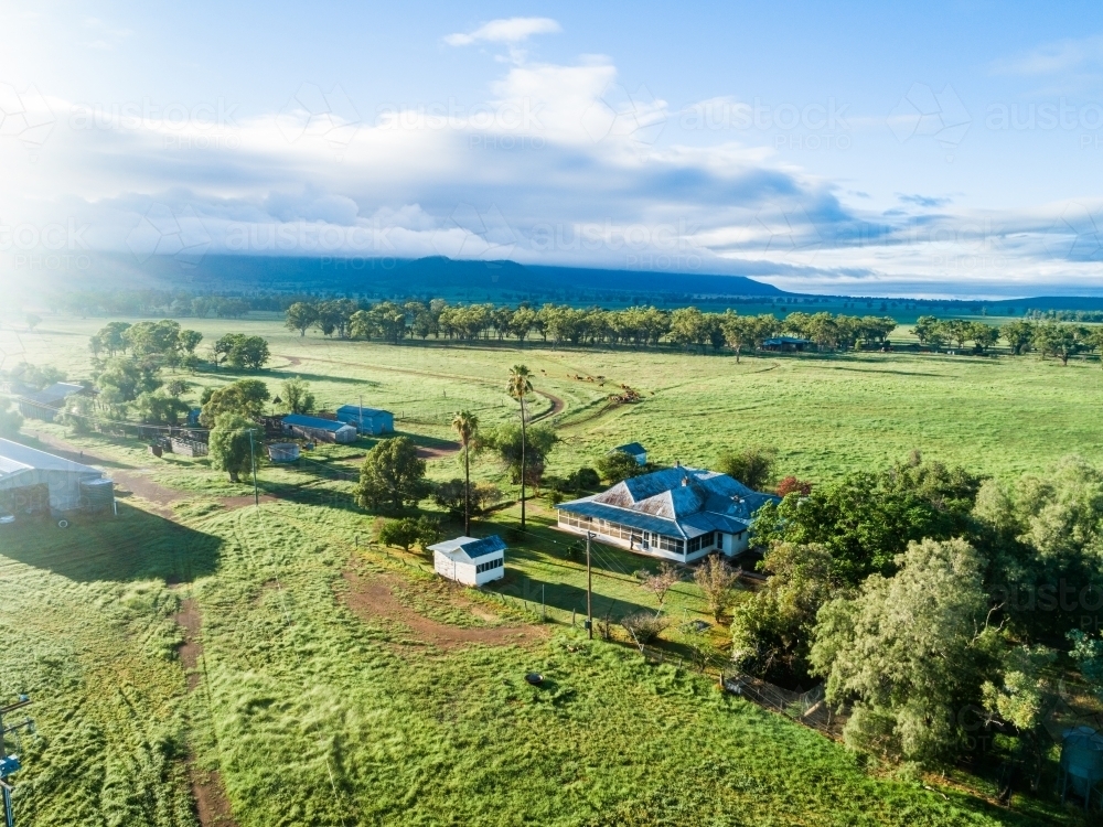 Morning light over rural farm homestead and green paddocks - Australian Stock Image