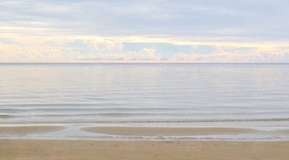 morning light reflecting off magnificent clouds and calm waters - Australian Stock Image