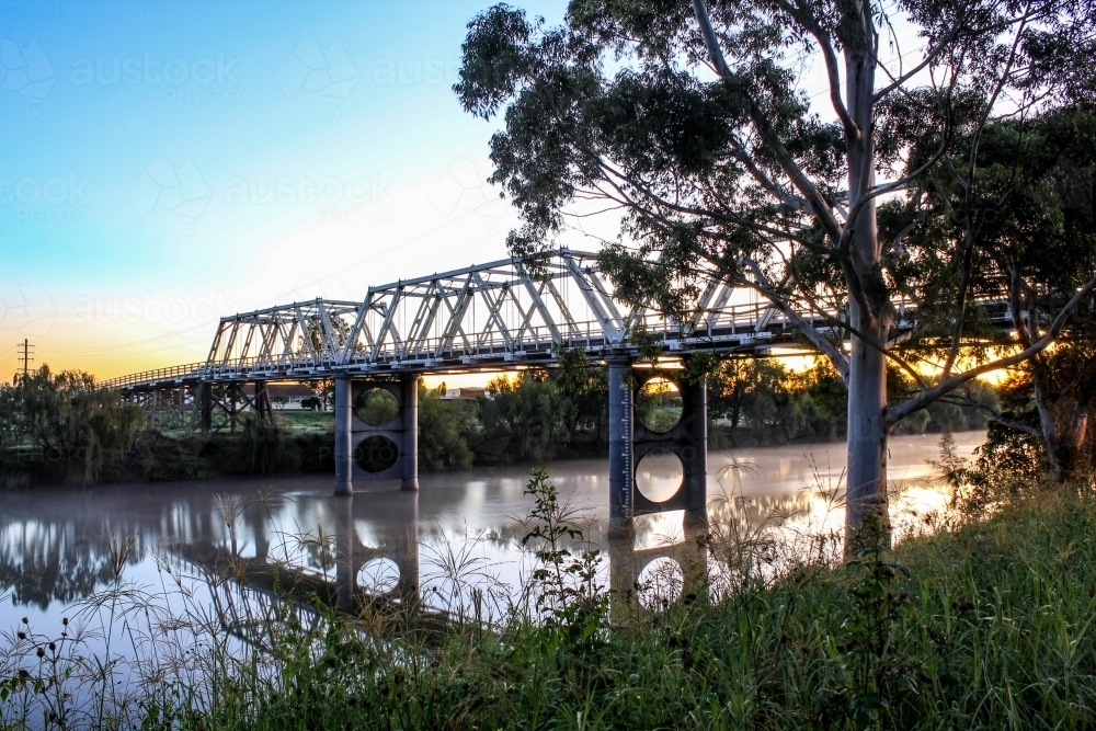 Morpeth bridge reflected in water early morning - Australian Stock Image