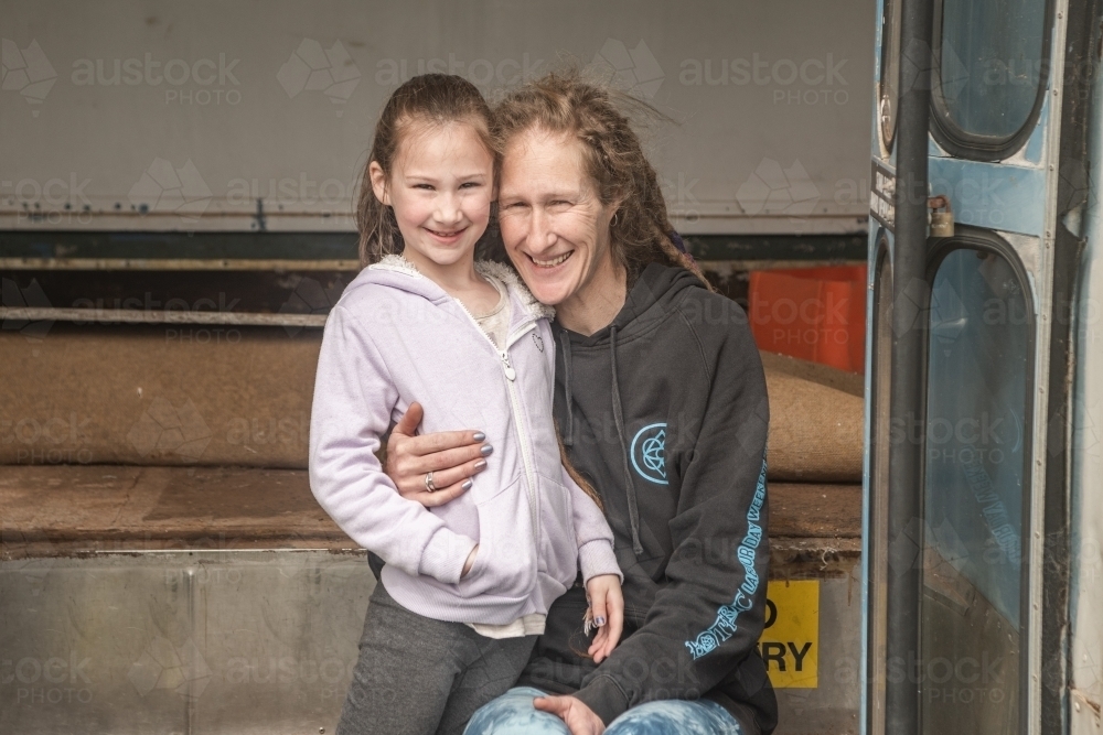 Mother and daughter on the steps on an old bus. - Australian Stock Image