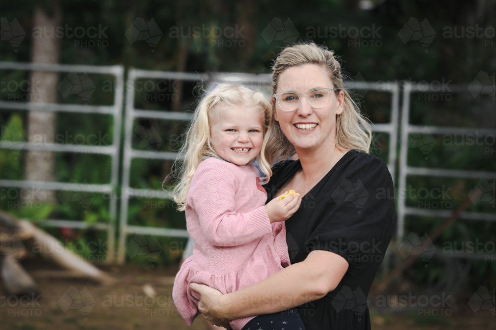 Mother and daughter sharing affectionate moment in the garden - Australian Stock Image