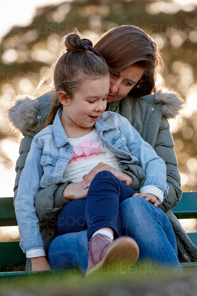 Mother and daughter sharing time at park - Australian Stock Image