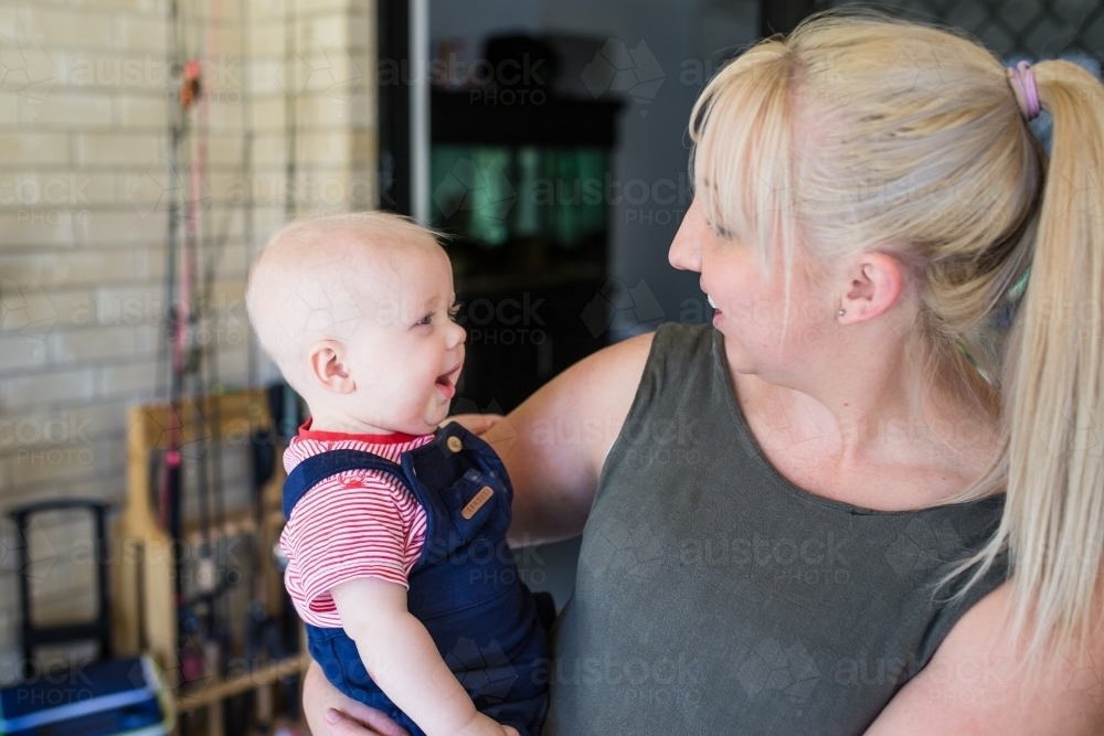 Mother and son looking at each other laughing - Australian Stock Image