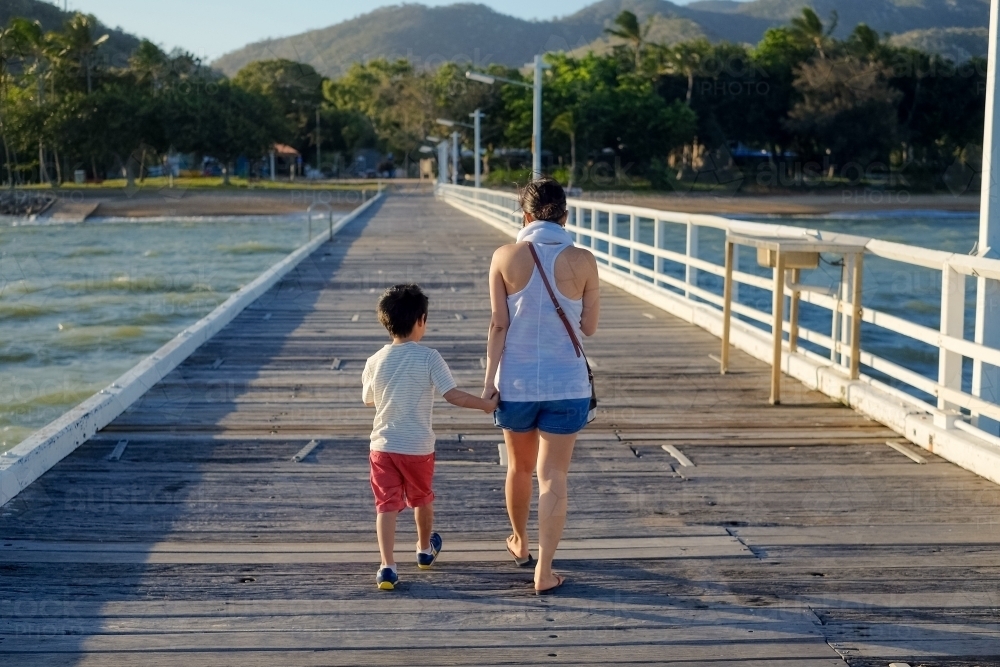 Mother and son walking down the jetty - Australian Stock Image