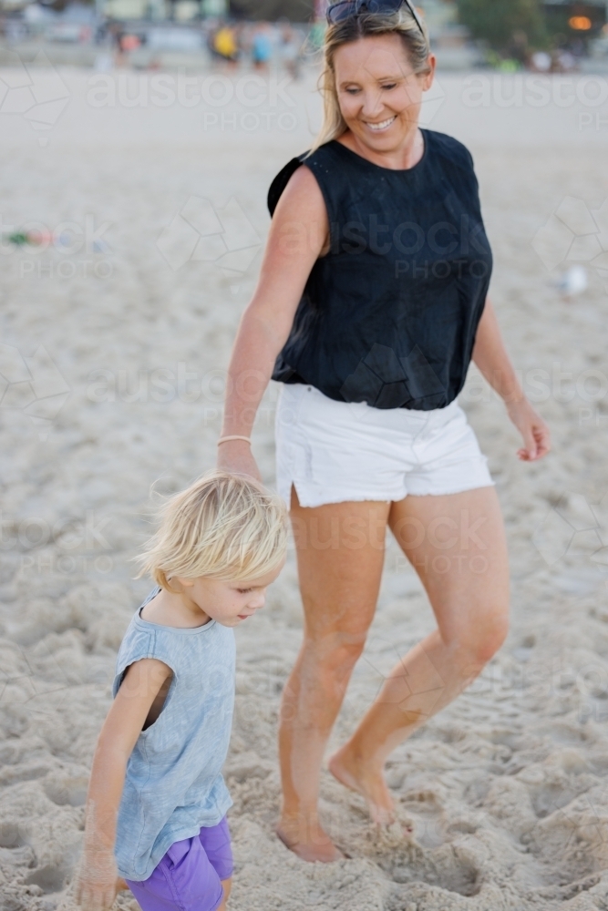 Mother and son walking on the beach at Surfers Paradise on the Gold Coast - Australian Stock Image