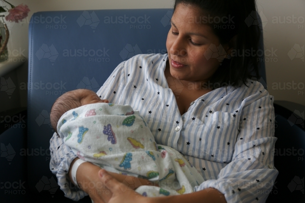 Mother cradling her newborn baby - Australian Stock Image