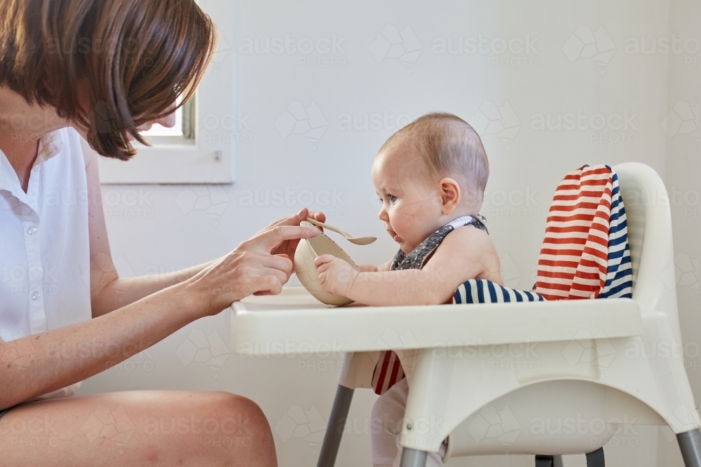 Mother feeding baby girl - Australian Stock Image