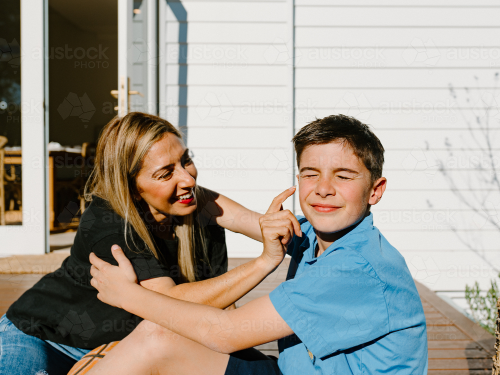 Mother touching the cheek of her son. - Australian Stock Image