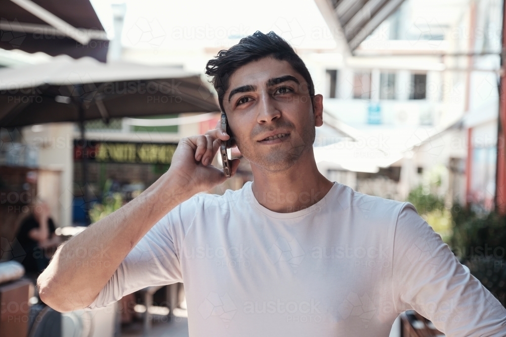 multicultural young adult man on the phone - Australian Stock Image