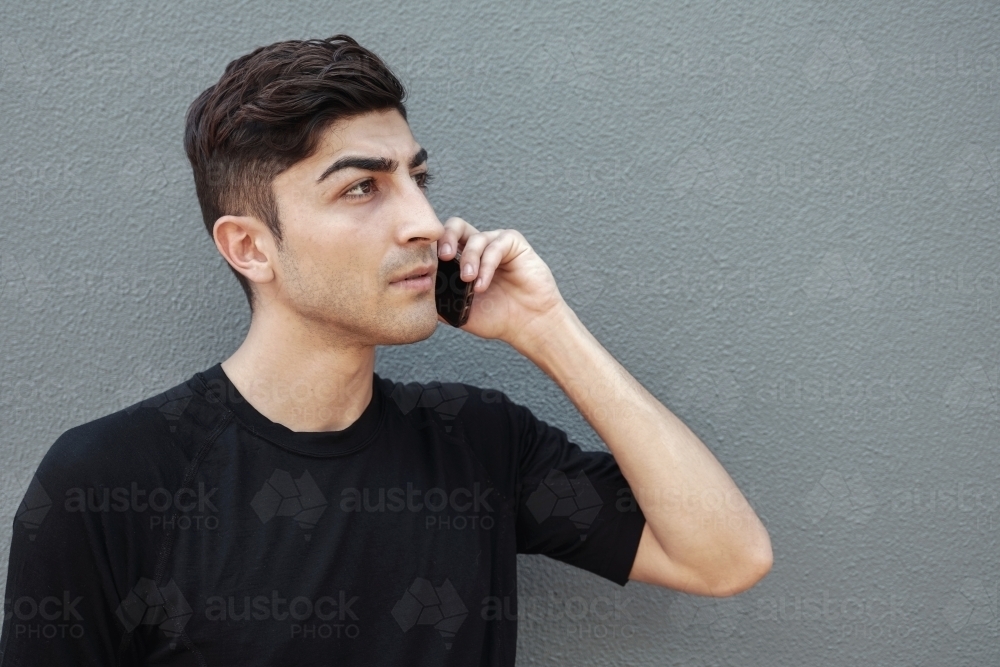 multicultural young adult man on the phone - Australian Stock Image