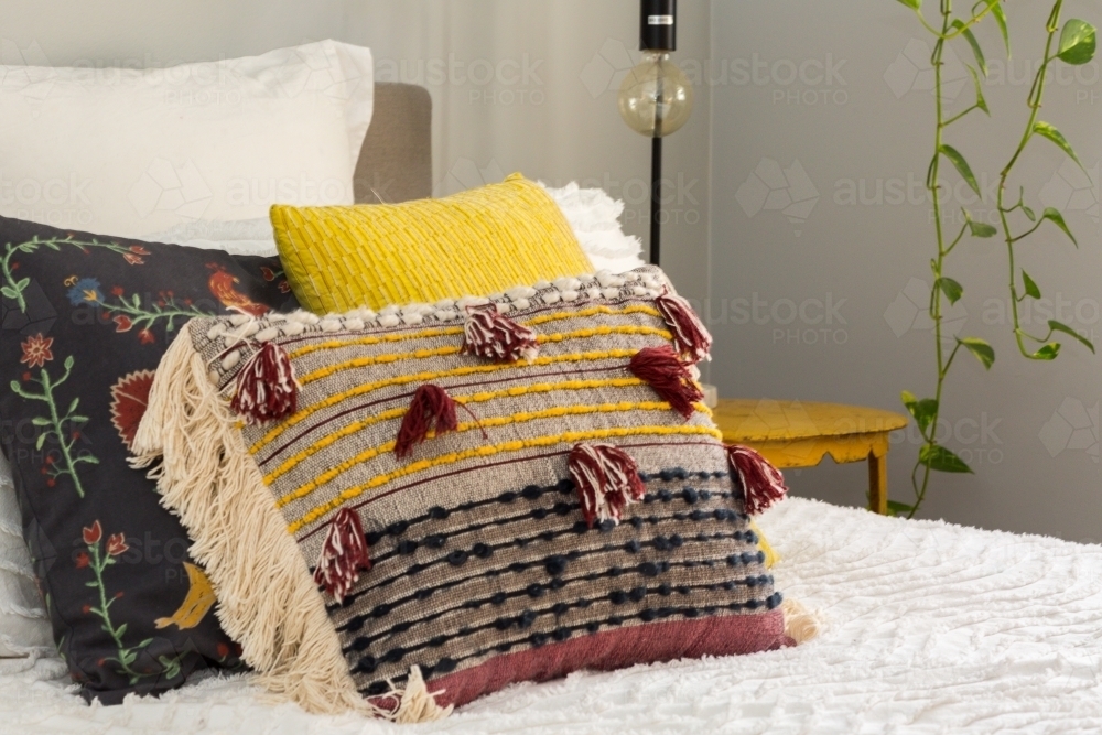 Multiple cushions on a bed - Australian Stock Image