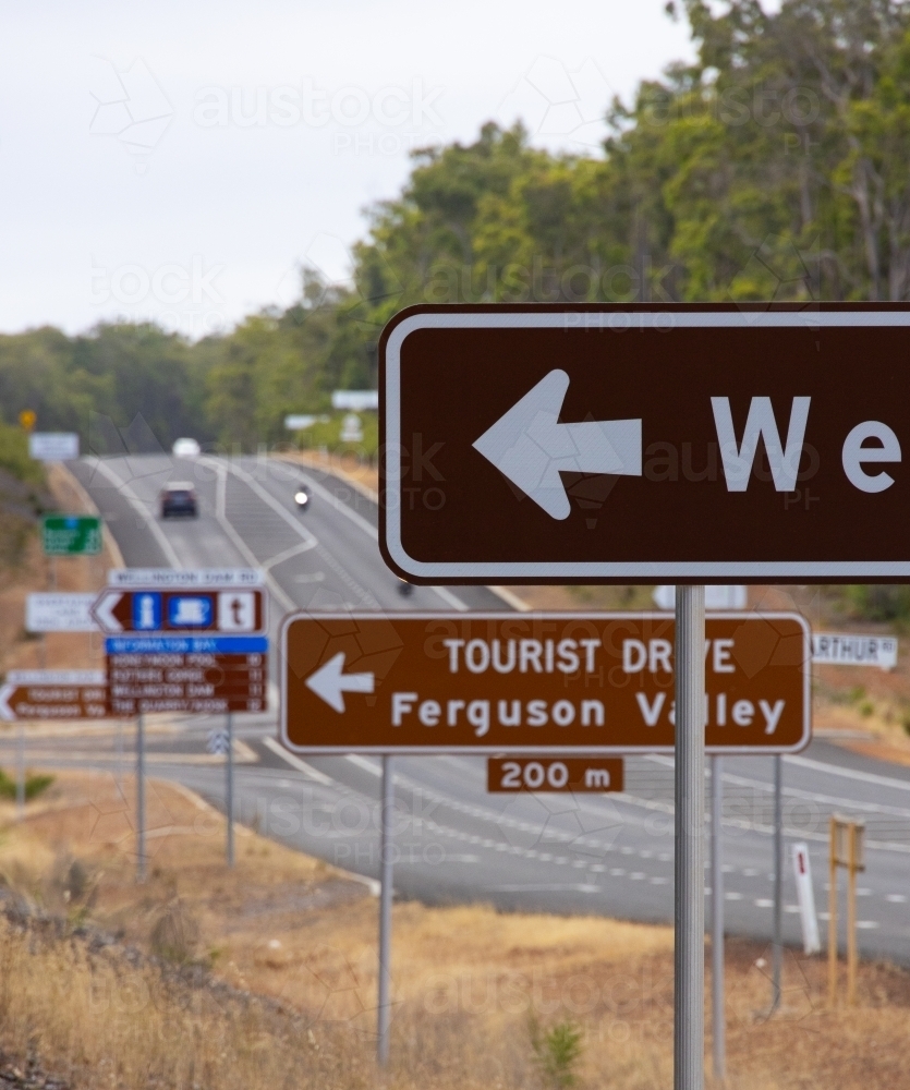 multitude of road signs on highway at intersection of Ferguson Valley tourist drive and highway - Australian Stock Image