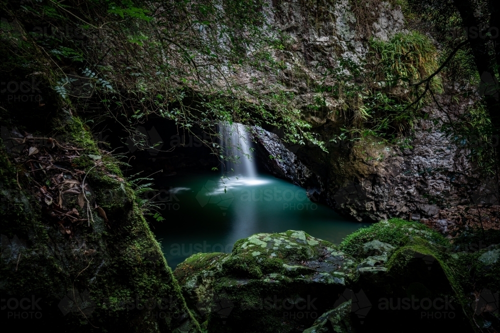 Natural Bridge with waterfall into cave - Australian Stock Image