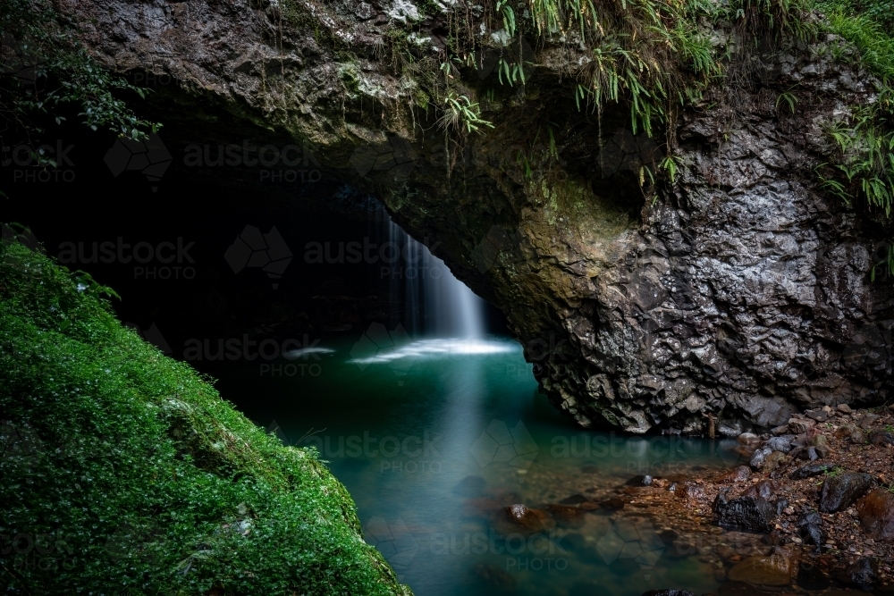 Natural Bridge with waterfall into cave - Australian Stock Image