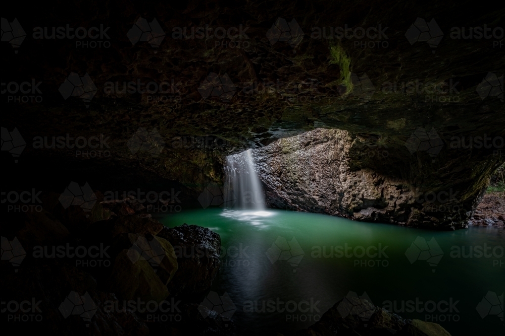 Natural Bridge with waterfall into cave - Australian Stock Image