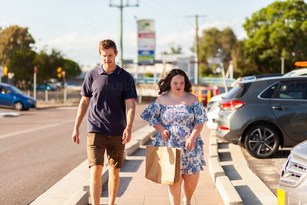 NDIS provider working with client providing community access support and assistance with shopping - Australian Stock Image