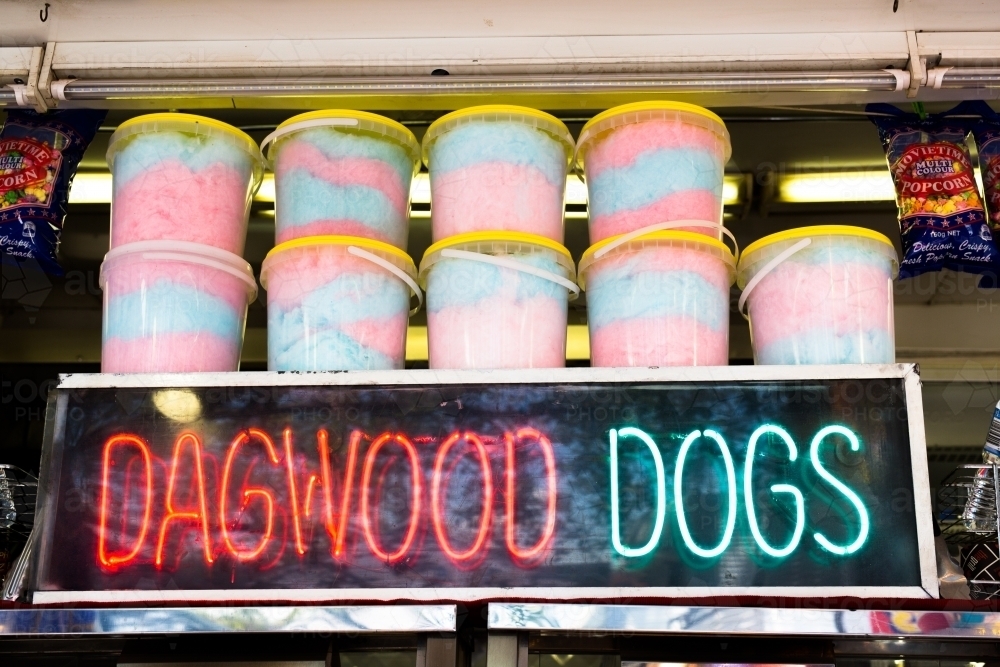 Neon dagwood dog sign and fairy floss in a side show alley - Australian Stock Image