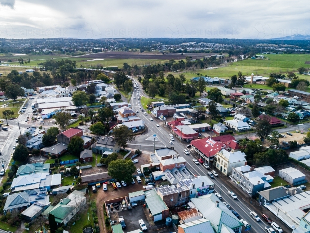 New England Highway through singleton with the australian red ensign on building roof - Australian Stock Image