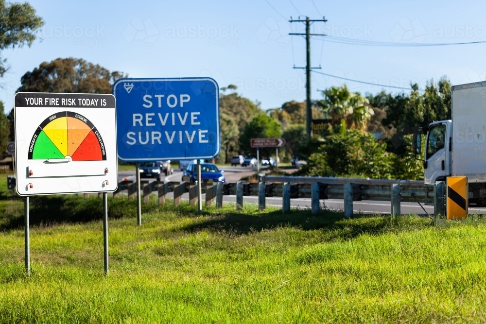 New fire danger rating and stop revive survive signs beside highway - Australian Stock Image