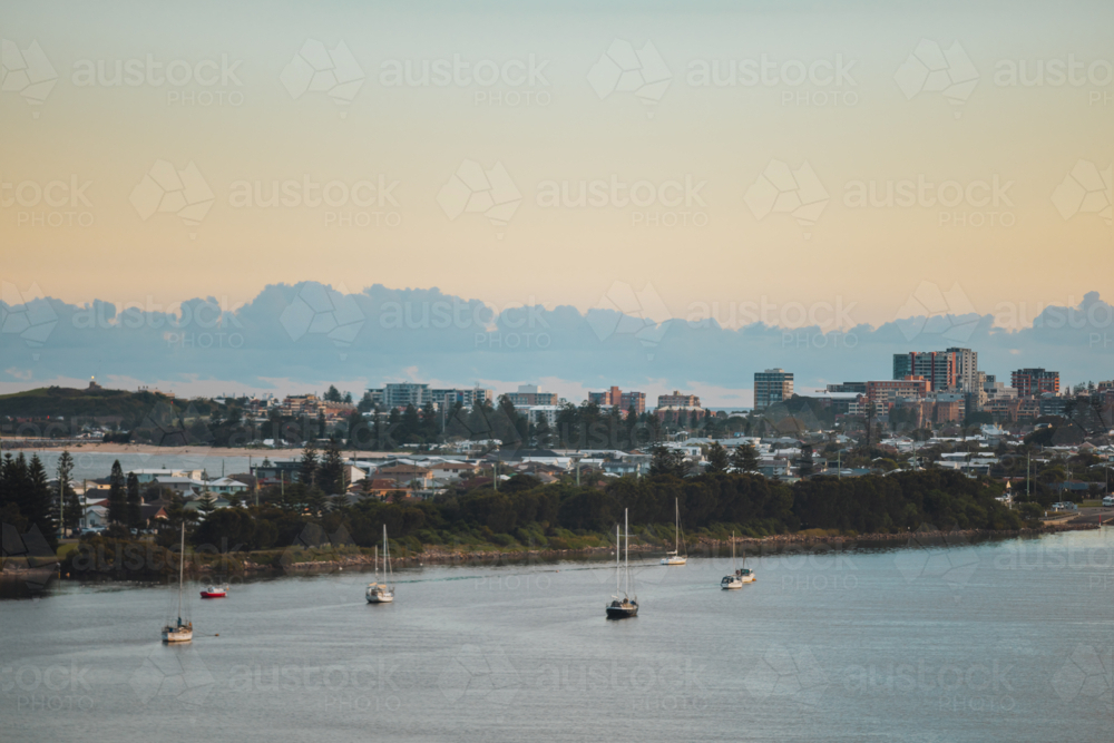 Newcastle city skyline in the evening with suburb of Stockton in the foreground - Australian Stock Image