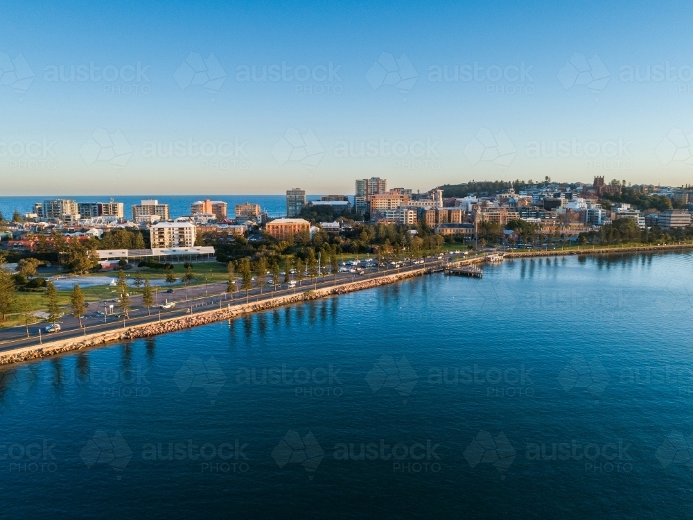 Newcastle foreshore with park and city behind seen from aerial view - Australian Stock Image