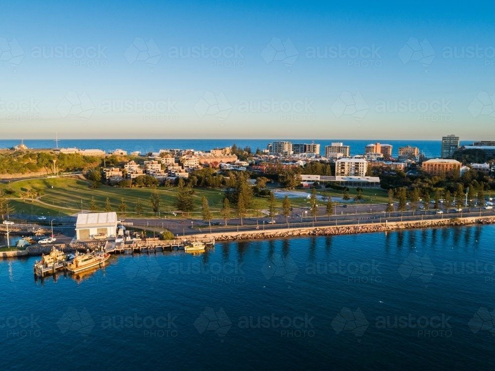 Newcastle foreshore with park and city behind seen from aerial view - Australian Stock Image