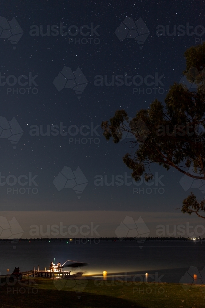 Night fishing off lake jetty - Australian Stock Image