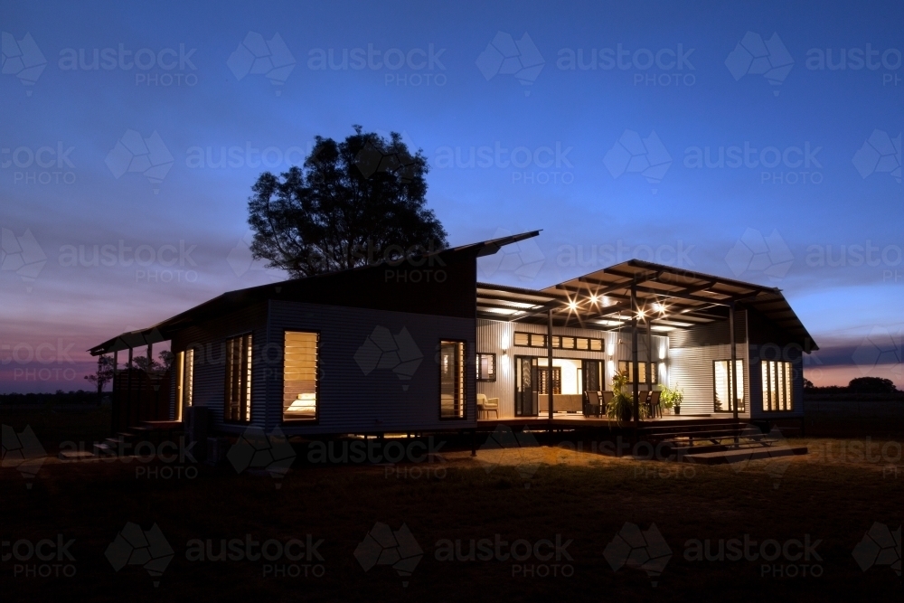 Nighttime shot of a modern architecture home. - Australian Stock Image