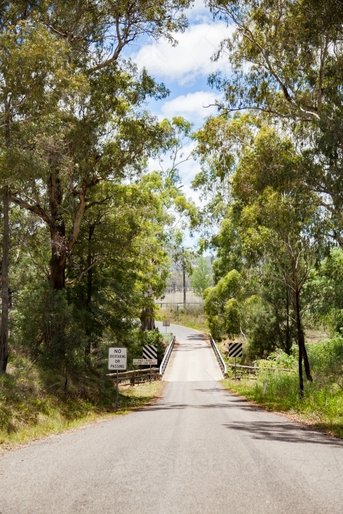 No overtaking or passing on narrow bridge over rural creek - Australian Stock Image