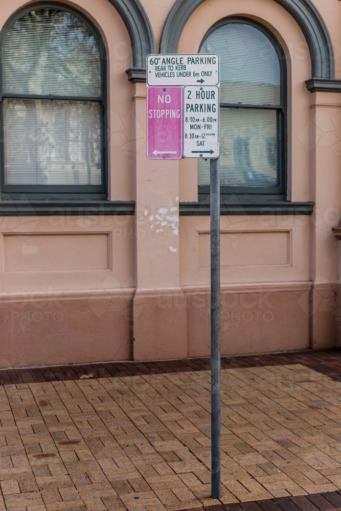 No stopping and parking street sign on brick footpath - Australian Stock Image