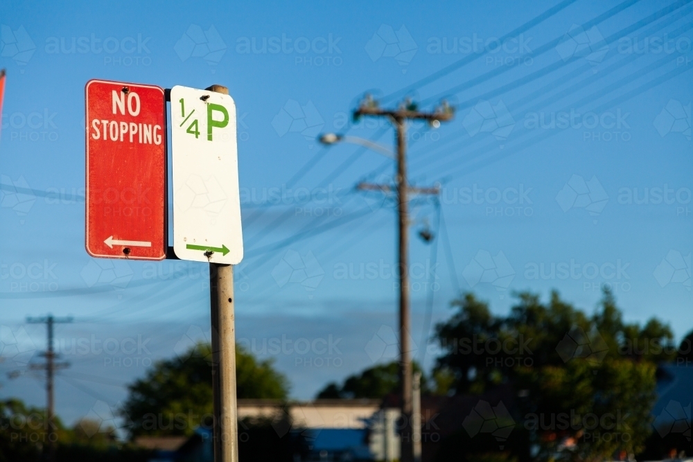 No stopping sign with arrow pointing one way and 1/4 hour parking sign the other way - Australian Stock Image