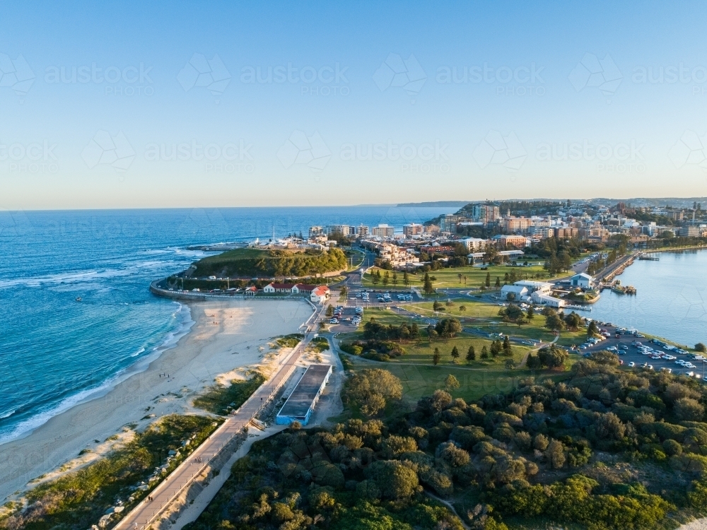 Nobbys beach and parkland in Newcastle seen from aerial view at sunset - Australian Stock Image