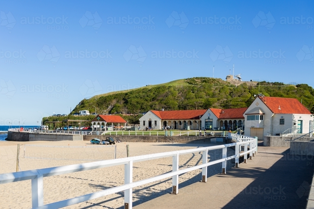 Nobbys Beach surf pavilion beside the sea on sunlit winter day - Australian Stock Image