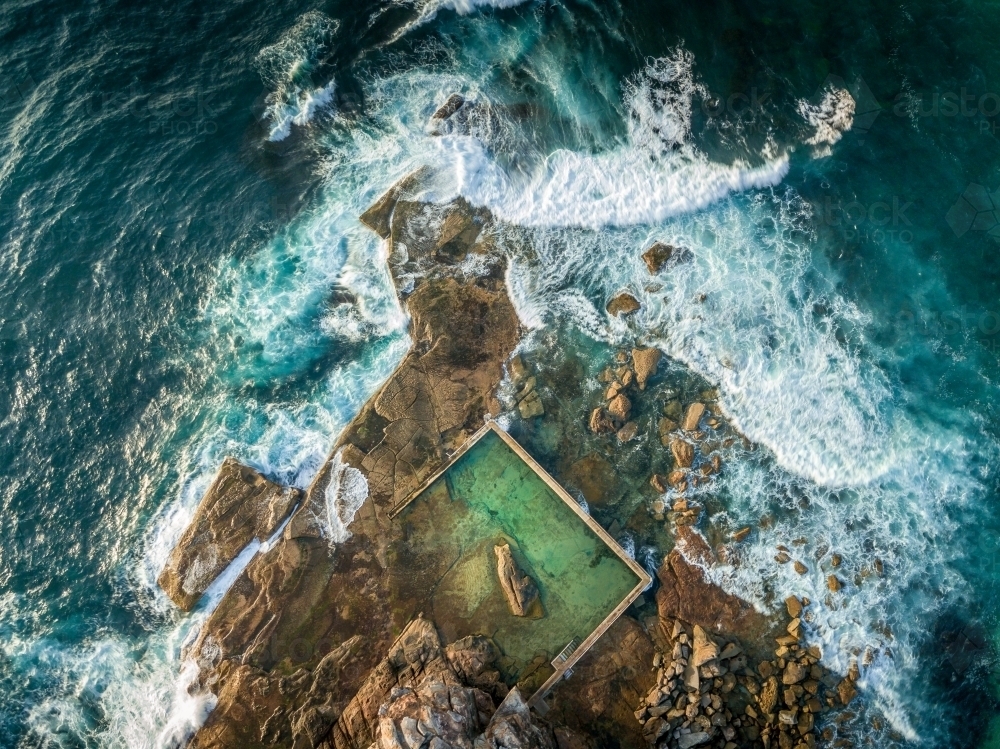 North Curl Curl Pool which lies on the rock shelf at the bottom of the cliffs.  Shot from above - Australian Stock Image