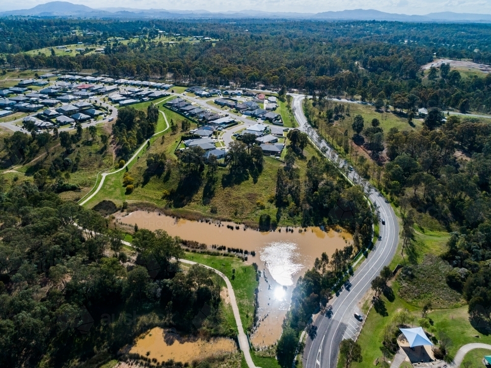 Nowlan park with Gardner circuit road going through it and a large dam in the waterway - Australian Stock Image