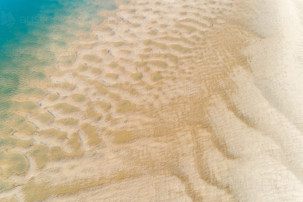 Oblique aerial view of patterns of a tidal sandbar in Seventeen Seventy, Queensland. - Australian Stock Image