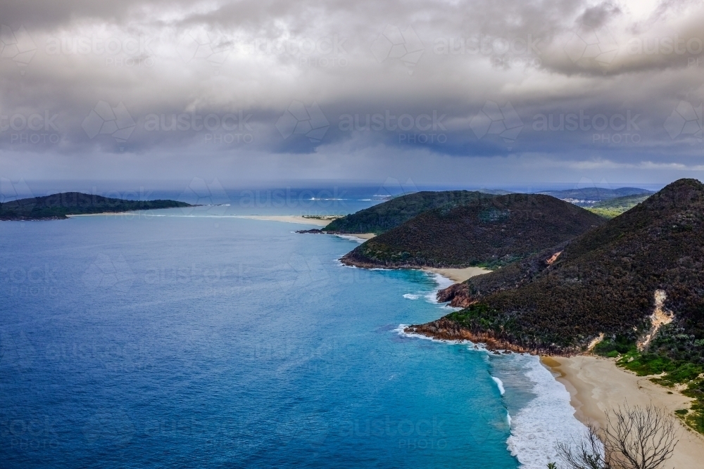 Ocean and mountains with cloudy sky - Australian Stock Image