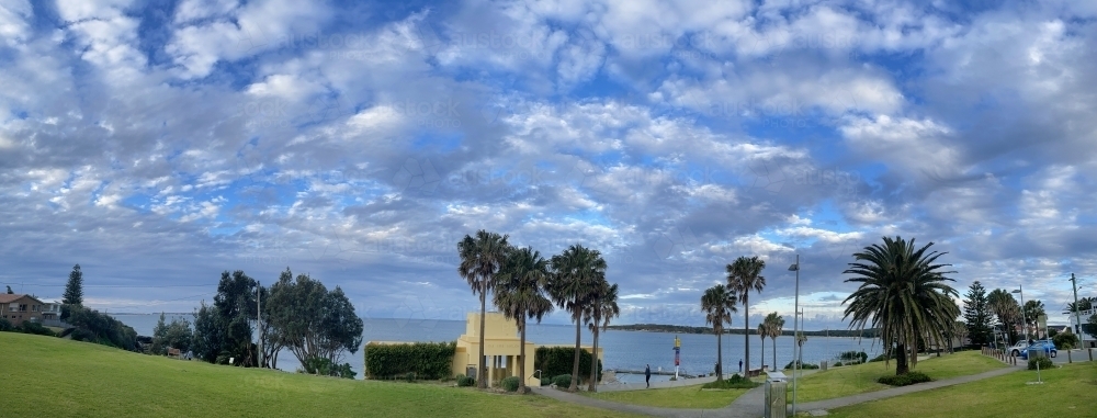 Ocean side park with a blue sky and white clouds - Australian Stock Image