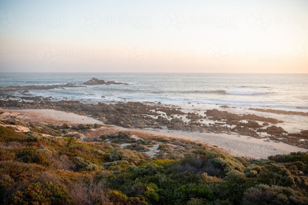 Ocean view of rugged coastline at sunset - Australian Stock Image