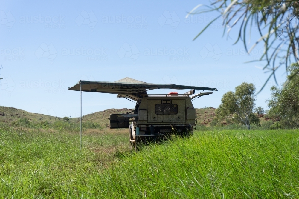 Off road 4wd ute setup with canopy and awning with lush green bush and hills in the background - Australian Stock Image