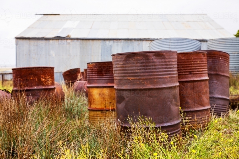 Old fuel drums near an iron shed - Australian Stock Image