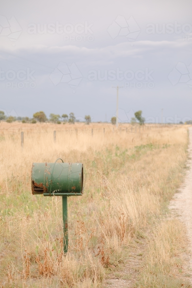 Old green mailbox on remote country road - Australian Stock Image