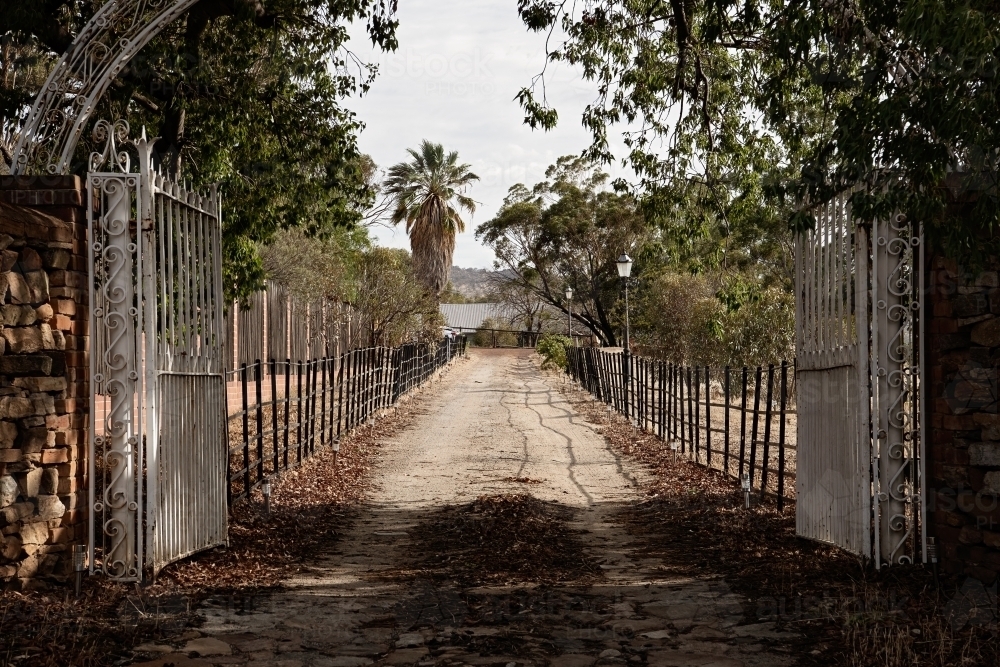 Old iron gates leading into a property - Australian Stock Image