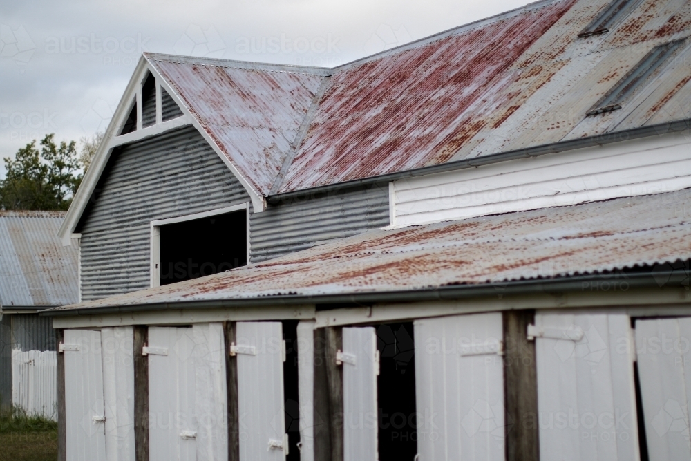 Old weathered work shed with timber doors and corrugated iron roofs - Australian Stock Image